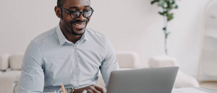 smiling-african-american-man-wearing-glasses-worki-CWQK3CT.jpg